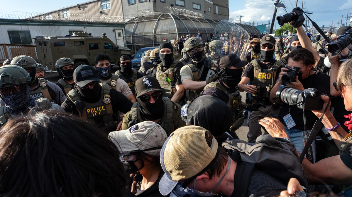 Protesters scuffle with masked immigration agents during a demonstration outside Delaney Hall, an immigration detention center in Newark, N.J., on Thursday evening, May 28, 2026. For nearly a week, relatives of migrants at Delaney Hall have said that some detainees have been on a hunger strike at the facility. Federal officials have denied that a hunger strike is taking place. (Todd Heisler/The New York Times)
