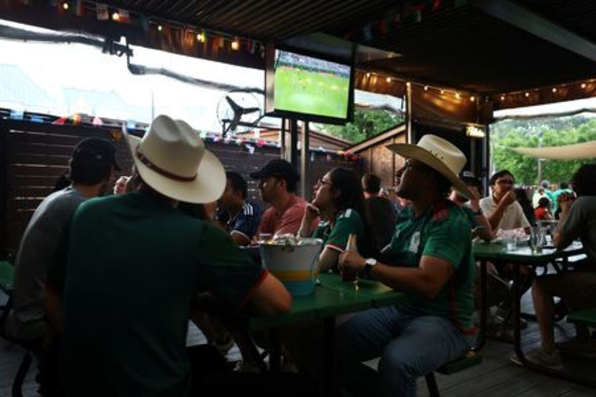 People watch a 2026 FIFA World Cup match between Mexico and South Korea, in Houston, Texas, U.S., June 18, 2026. REUTERS/Pedro Nunes