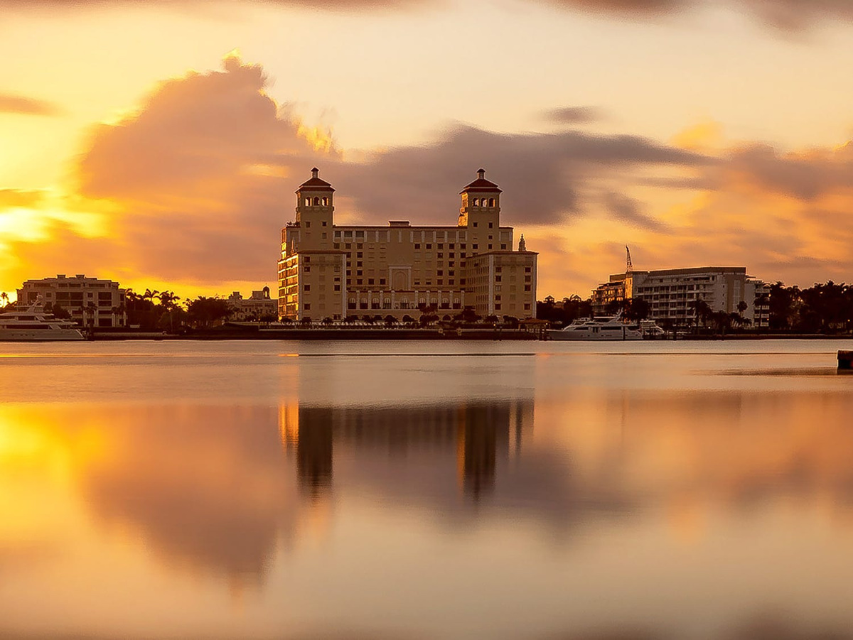 The sun rises behind the Palm Beach Biltmore condominium in Palm Beach.