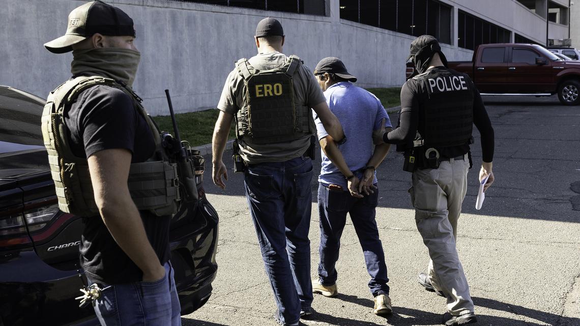 ICE agents  take an immigrant into custody after a court hearing in Connecticut.