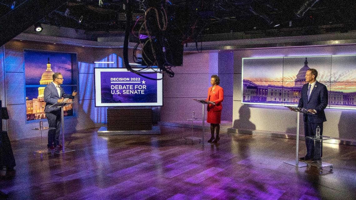Spectrum News 1 political anchor Tim Boyum, left, moderates a televised debate between Democratic candidate for U.S. Senate Cheri Beasley, center, and Republican challenger U.S. Rep. Ted Budd, R-N.C., Friday, Oct. 7, 2022, at Spectrum News 1 studio in Raleigh, N.C. (Travis Long/The News & Observer via AP, Pool)