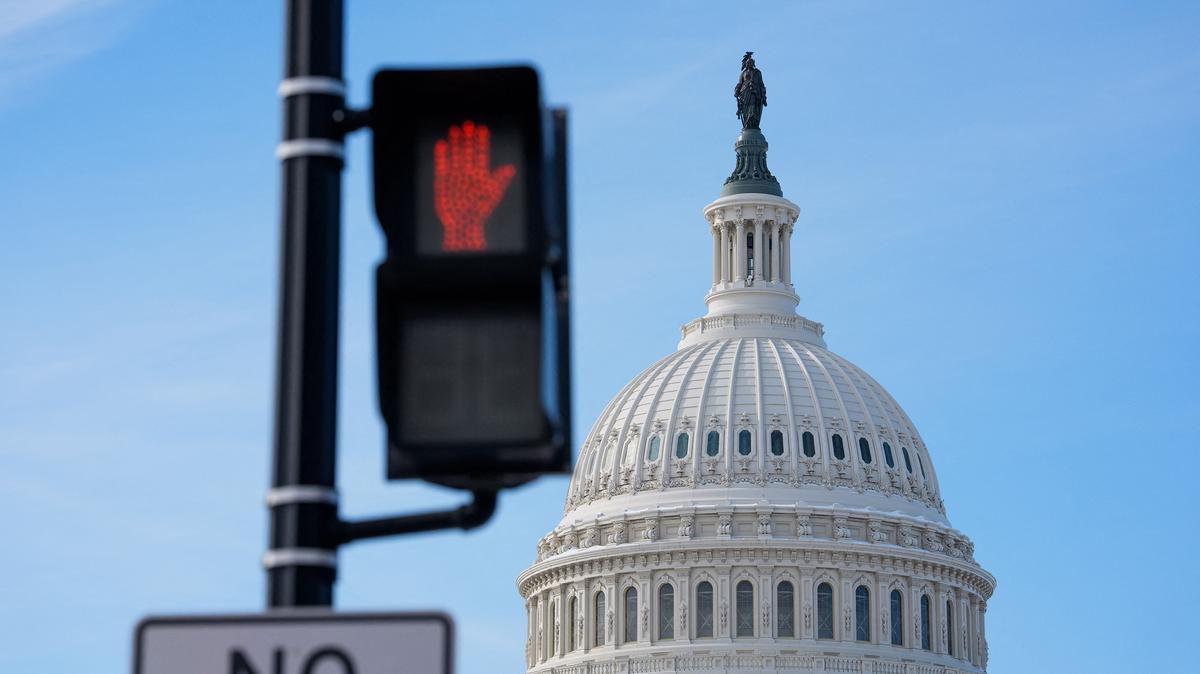 A "Don't Walk" pedestrian signal is visible near the U.S. Capitol in Washington, D.C., on Jan. 31, 2026. Government shutdowns have become increasingly more common in recent years as political polarization grips Washington.