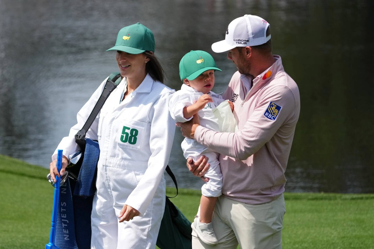  Apr 8, 2026; Augusta, Georgia, USA; Sam Burns with his wife Caroline and son Bear on the fourth hole during the Par 3 Contest at the Masters Tournament at Augusta National Golf Club. Mandatory Credit: Michael Madrid-Imagn Images 