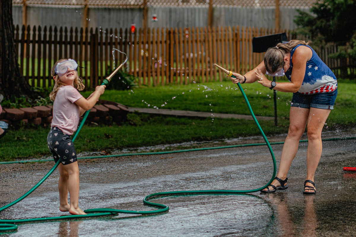 Children play water games in the streets during The Fourth of July parade in the small town of New Market, Iowa, July 4, 2026. America celebrates the 250th anniversary of its independence today, with people from one end of the country to the other marking the milestone with fireworks, parades and concerts. (Jamie Kelter Davis/The New York Times)