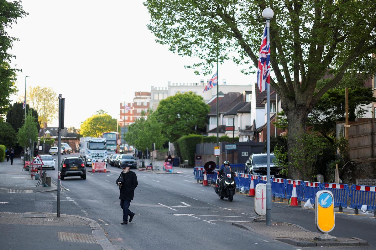 A man walks near the scene where a man was arrested on Wednesday following a stabbing incident in which two Jewish men were wounded in the Golders Green area, which is home to a large Jewish population, in London, Britain, April 30, 2026. REUTERS/Hannah McKay