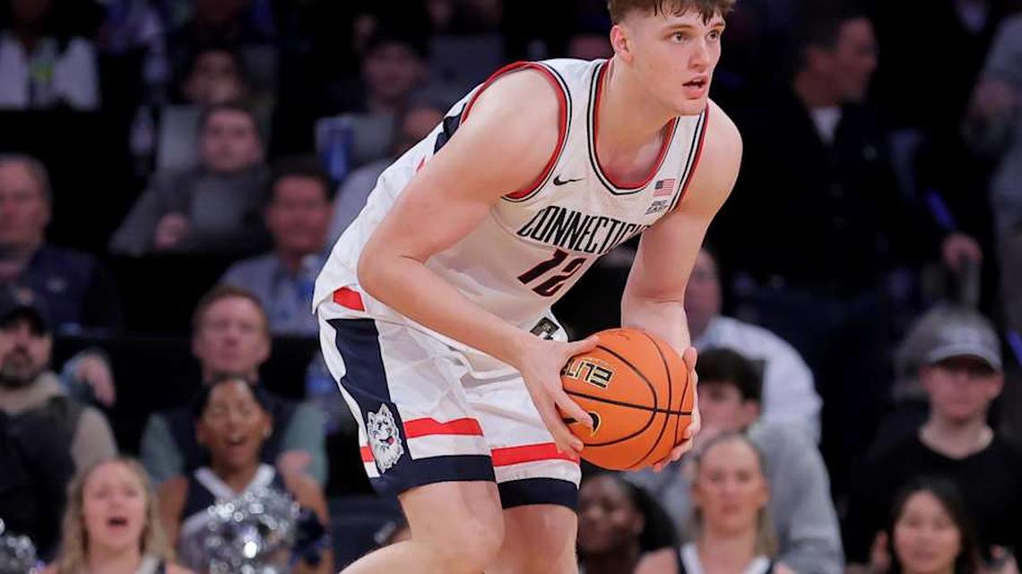  Mar 13, 2026; New York, NY, USA; Connecticut Huskies center Eric Reibe (12) looks to pass the ball against the Georgetown Hoyas during the second half at Madison Square Garden. Mandatory Credit: Brad Penner-Imagn Images | Brad Penner-Imagn Images 