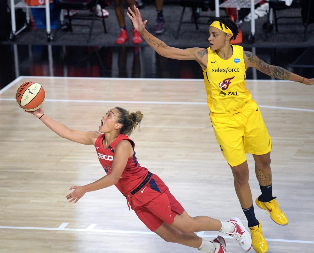 Kennewick High grad and Washington Mystics guard Leilani Mitchell, left, makes a basket after being fouled by Indiana Fever forward Candice Dupree (4) during the first half of a WNBA basketball game July 25 in Ellenton, Fla. (AP Photo/Phelan M. Ebenhack)