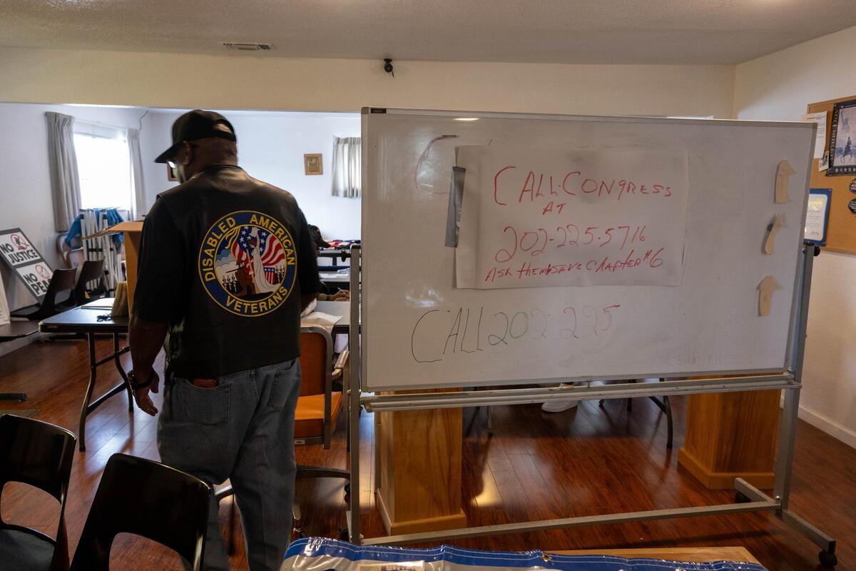 Former Chapter 6 Treasurer Eldra Jackson Jr. walks by a whiteboard with a plea to save the chapter at its home in Sacramento. (Photo by Paul Kitagaki, Jr. for the Sacramento Bee)