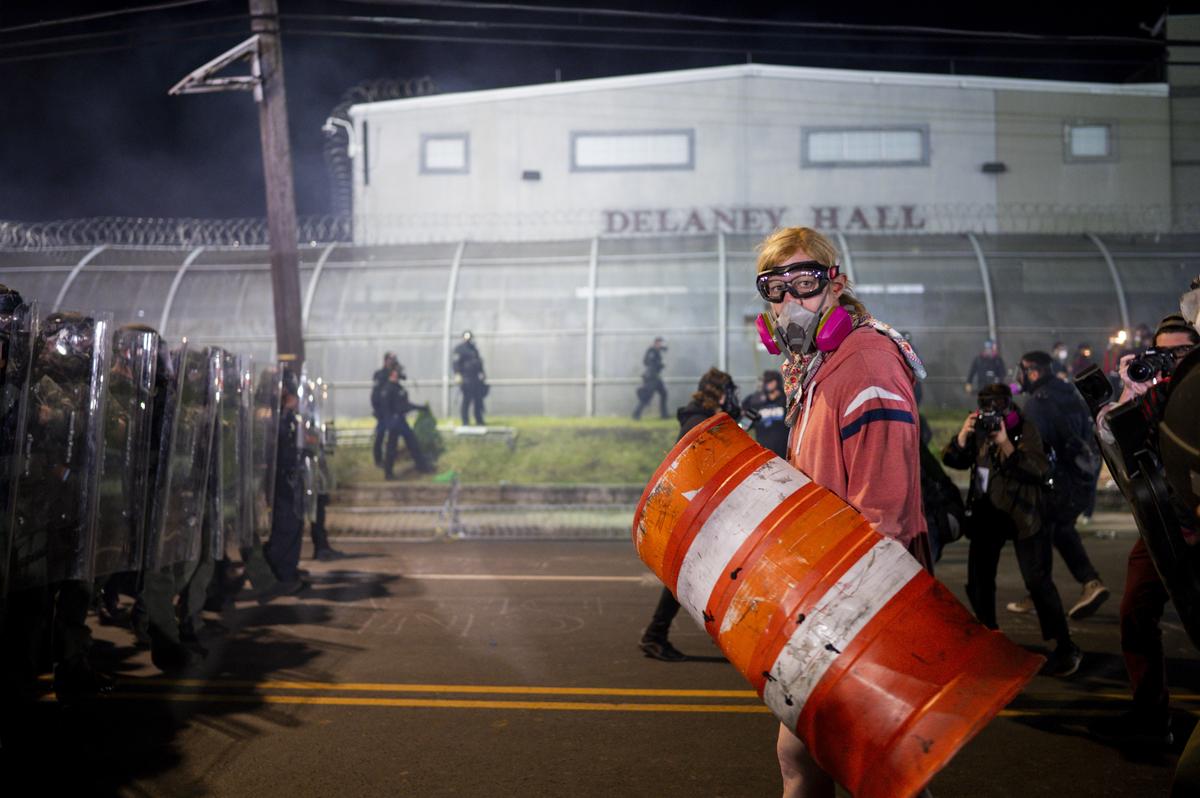 Demonstrators and police officers outside the Delaney Hall immigration detention center in Newark, N.J., May 30, 2026. Mayor Ras Baraka of Newark imposed a curfew early Sunday around the immigration detention center after a second consecutive night of unrest over living conditions there. (Vincent Alban/The New York Times)