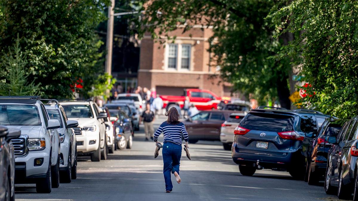 A mother runs barefoot toward the chaotic scene at Annunciation Catholic Church and School after a shooting during the first morning Mass of the school year on Aug. 27, 2025.
