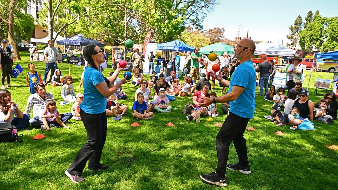 EarthCapades performers Lissin Lev Chaya, from left, and Hearty Heartlife juggle while singing songs during a Earth Day Celebration held at Civic Park in Walnut Creek, Calif., on Saturday, April 20, 2024. About 250 people attended the event. (Jose Carlos Fajardo/Bay Area News Group)