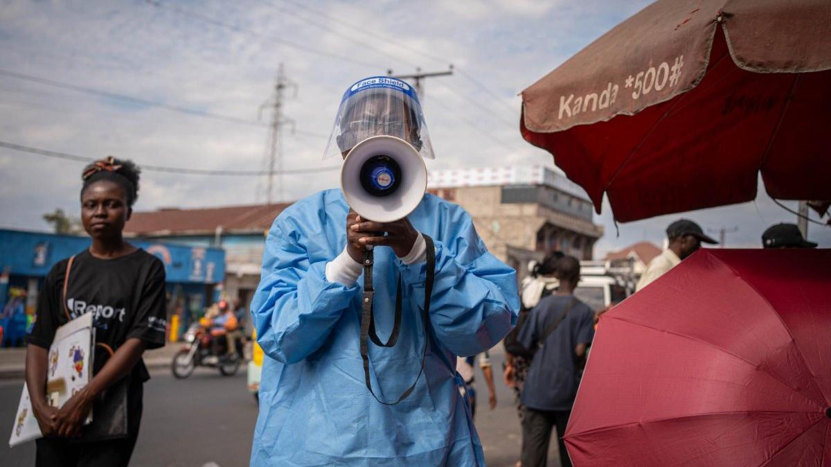 A coordinator with U-Reporters, an UNICEF program to engage and inform local communities, wears a protective gown as he takes part in a campaign to raise awareness against Ebola in Goma, North Kivu, Democratic Republic of the Congo, on Friday. Photo by Jeanne Munyerenkana/EPA