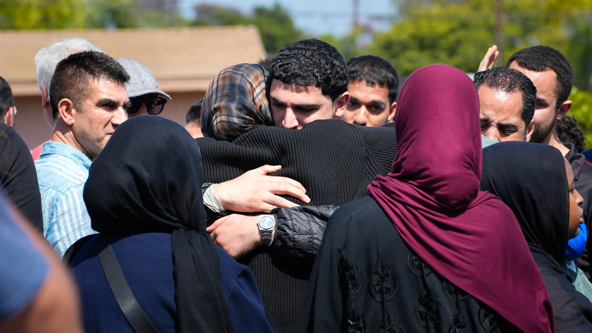 On May 18, 2026, in San Diego, not far from the Islamic Center of San Diego, several people embrace one another after shootings left five dead, including two teenage suspects. A security guard at the Islamic Center of San Diego was among those killed outside the building, police said. (Nelvin C. Cepeda/The San Diego Union-Tribune/TNS)