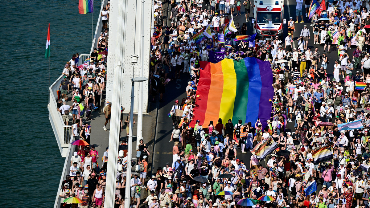 People cross Elizabeth Bridge with a rainbow flag as they attend the Budapest Pride March in Budapest, Hungary, June 27, 2026. REUTERS/Marton Monus