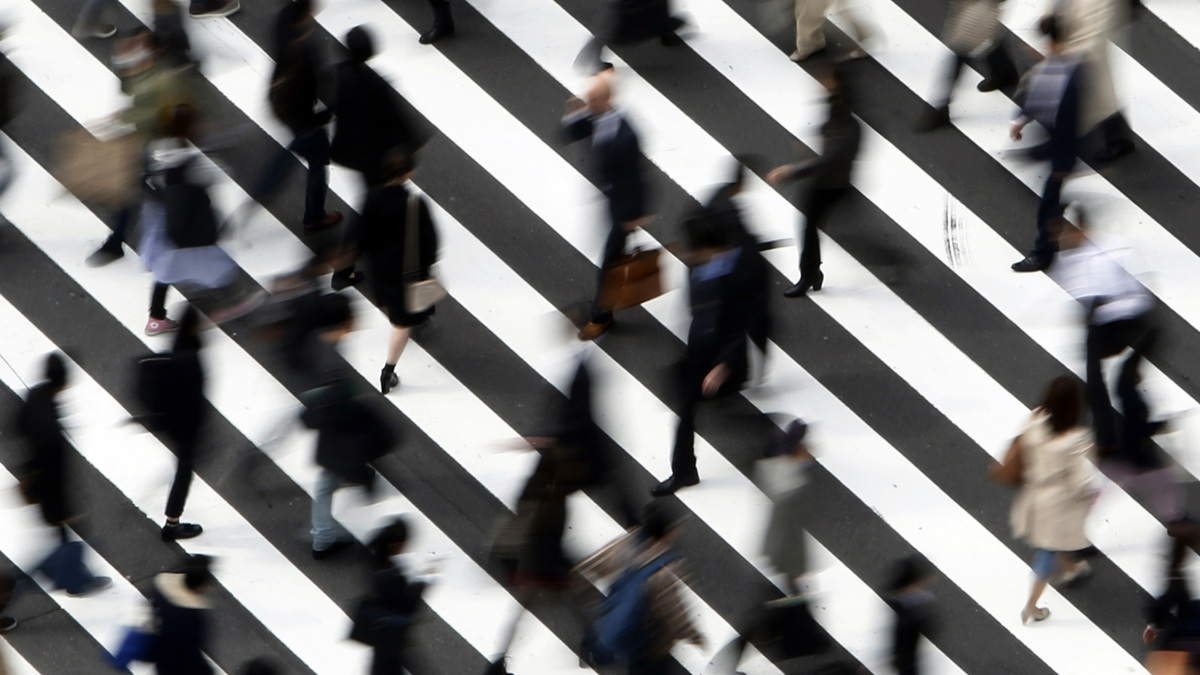 FILE PHOTO: People cross a street in Tokyo March 18, 2015. REUTERS/Yuya Shino/File Photo