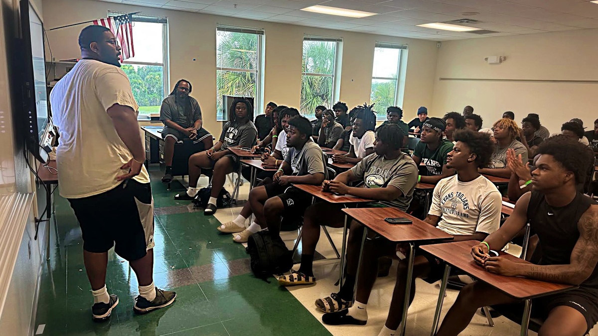 Teams open football practice, but weather interferes; Evans has high hopes