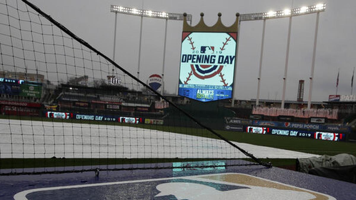 Rain falls on the home team dugout before an opening day baseball game between the Kansas City Royals and the Chicago White Sox at Kauffman Stadium in Kansas City, Mo., Thursday, March 28, 2019.