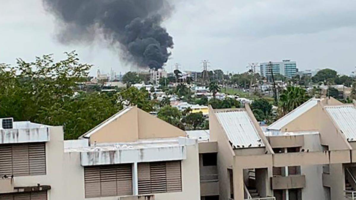 A plume of smoke rises from a fire at an electrical substation that left hundreds of thousands of people without power in San Juan, Puerto Rico, on June 10, 2021. Puerto Rico has struggled with its power grid for years.