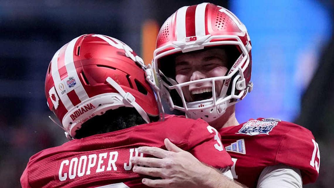  Indiana Hoosiers quarterback Fernando Mendoza (15) celebrates with Indiana Hoosiers wide receiver Omar Cooper Jr. (3) celebrate after connecting for a touchdown Friday, Jan. 9, 2026, during the Peach Bowl and semifinal game of the College Football Playoff against the Oregon Ducks at Mercedes-Benz Stadium in Atlanta. | Grace Hollars/IndyStar / USA TODAY NETWORK via Imagn Images 