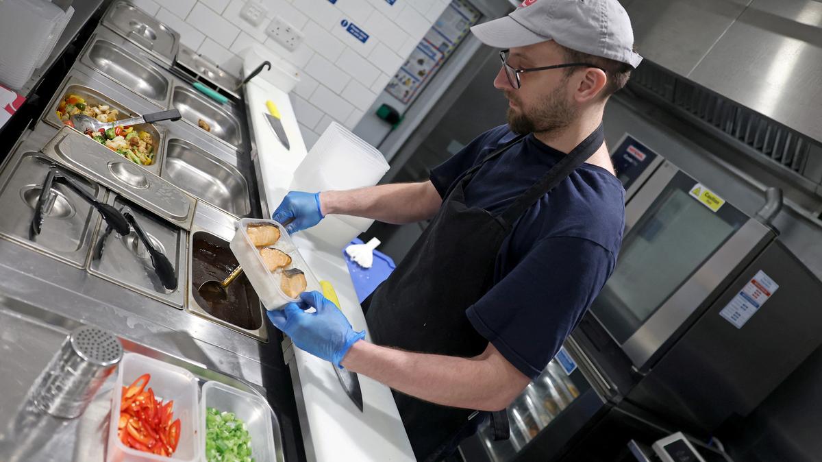 Team member Bartosz prepares a meal for takeaway at a K10 Japanese restaurant in London, Britain, January 16, 2026. REUTERS/Toby Melville