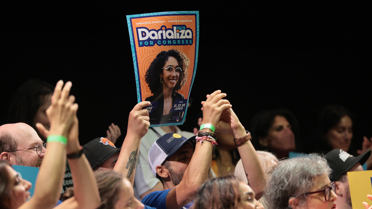 A person holds up a Congressional candidate Darializa Avila Chevalier sign as she speaks during a Get Out the Vote rally at Kings Theater on June 18, 2026, in New York City.