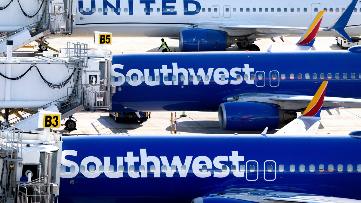 Southwest and United Airlines sit at the gate at Palm Beach International Airport on March 11, 2026, in West Palm Beach, Florida.