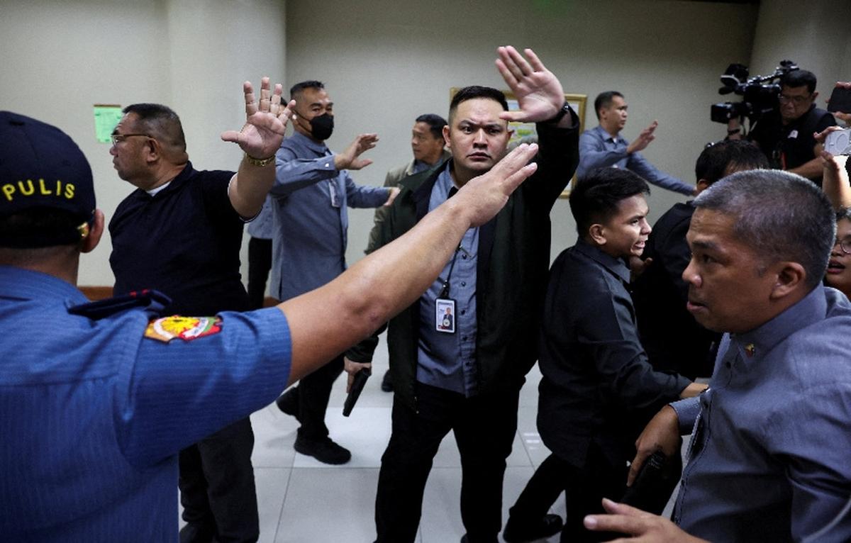FILE PHOTO: Senate security personnel and police officers ask members of the media to stay back after gunshots were heard at the Philippine Senate, as chaos mounted in anticipation of an attempt to arrest a top senator wanted by the International Criminal Court, in Pasay City, Metro Manila, Philippines, May 13, 2026. REUTERS/Eloisa Lopez/File Photo