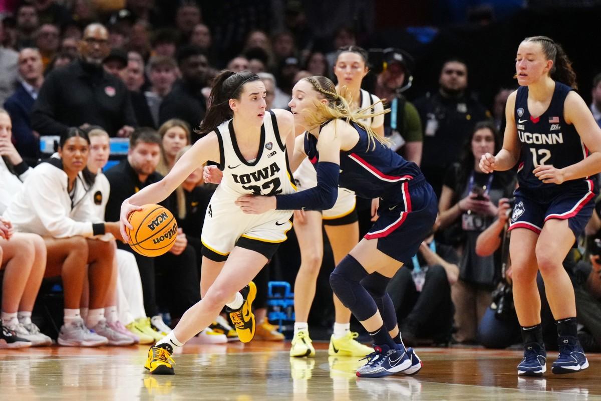  Former Iowa Hawkeyes guard Caitlin Clark controls the ball against Connecticut Huskies guard Paige Bueckers. Kirby Lee-Imagn Images