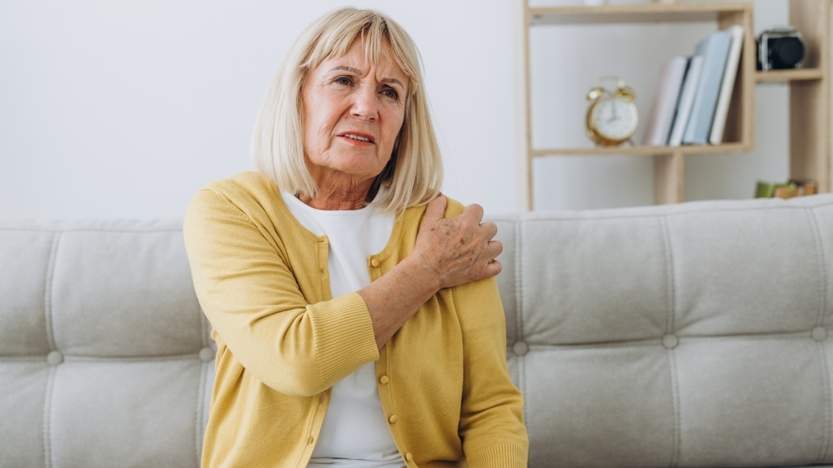 Senior woman with shoulder pain. Elderly woman is enduring awful ache. Shoulder Pain In An Elderly Person. Senior lady with shoulder pain