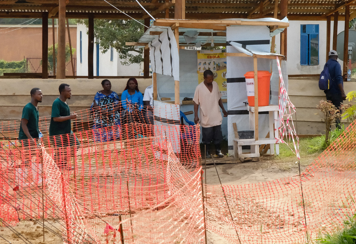 People move at the Ebola Virus Disease Treatment Center of the Bunia General Reference Hospital, one month after cases were confirmed in Bunia, eastern Democratic Republic of Congo, June 15, 2026. REUTERS/Gradel Muyisa Mumbere