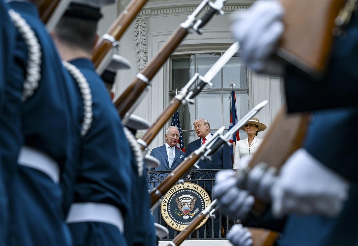 From right: first lady Melania Trump, President Donald and Trump, King Charles III watch a pass in review from a balcony of the White House during an arrival ceremony in Washington, on Tuesday, April 28, 2026. (Kenny Holston/The New York Times)