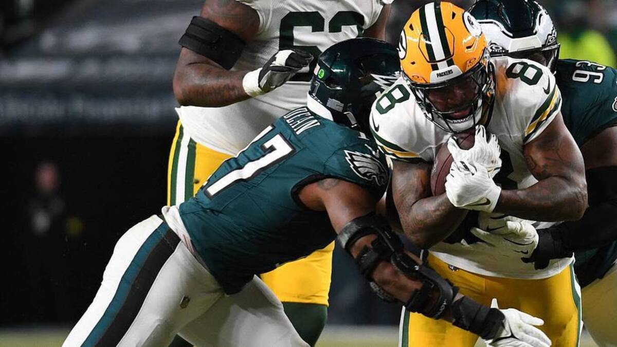  Jan 12, 2025; Philadelphia, Pennsylvania, USA; Green Bay Packers running back Josh Jacobs (8) rushes the ball against Philadelphia Eagles defensive tackle Milton Williams (93) and linebacker Nakobe Dean (17) during the first half in an NFC wild card game at Lincoln Financial Field. Mandatory Credit: Eric Hartline-Imagn Images | Eric Hartline-Imagn Images 