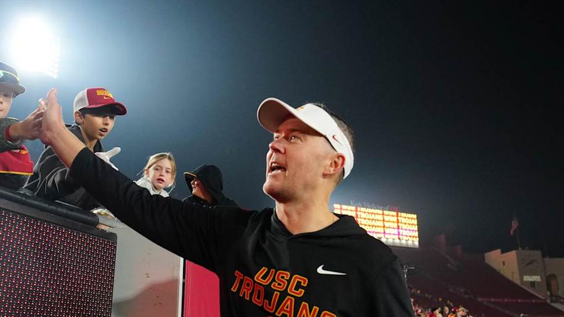 Nov 29, 2025; Los Angeles, California, USA; Southern California Trojans head coach Lincoln Riley celebrates with fans after the game against the UCLA Bruins at United Airlines Field at Los Angeles Memorial Coliseum. Mandatory Credit: Kirby Lee-Imagn Images | Kirby Lee-Imagn Images 