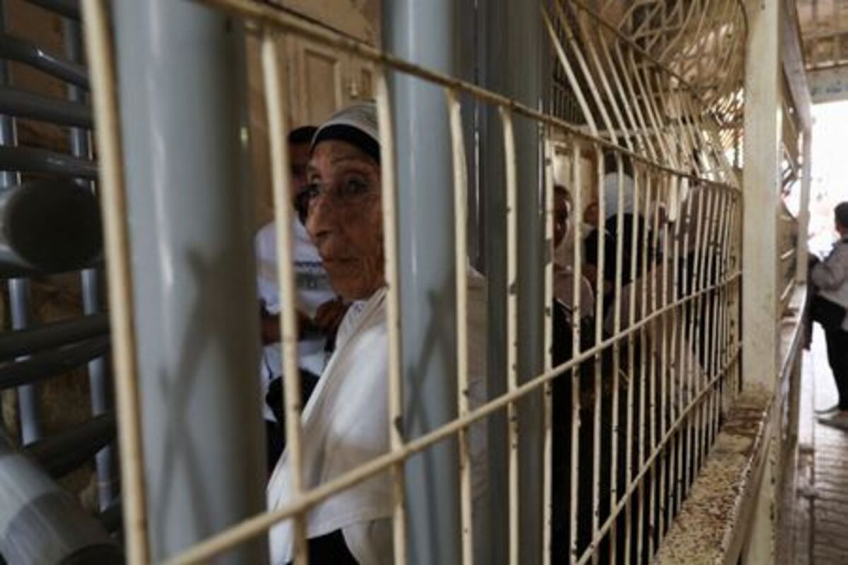 Palestinians wait at an Israeli checkpoint as they head for prayer at the Ibrahimi Mosque, also known as the Cave of Patriarchs, in the old city of Hebron, in the Israeli-occupied West Bank, June 17, 2026. REUTERS/Ammar Awad