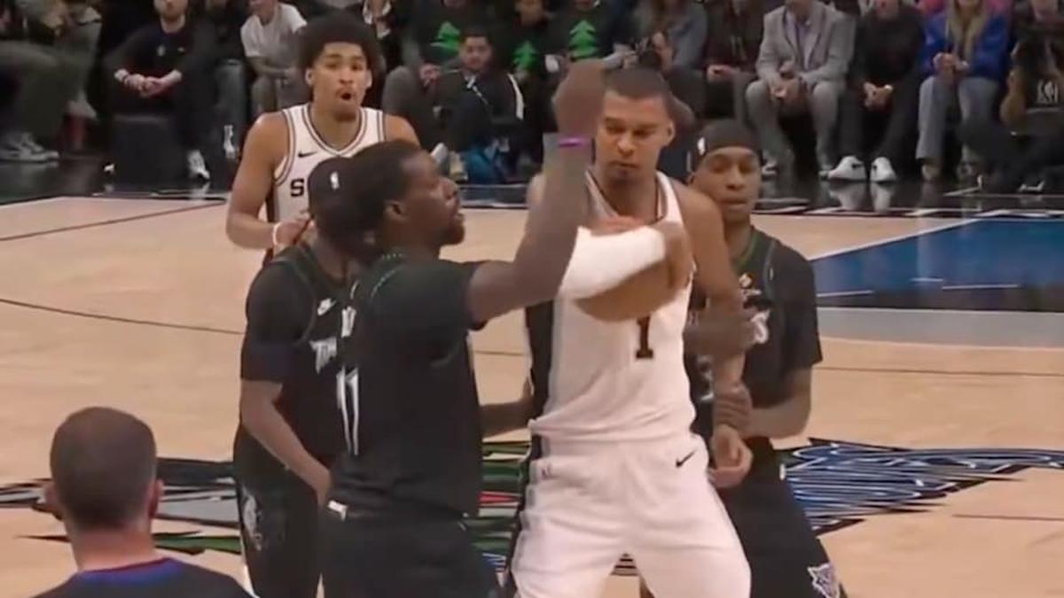  Victor Wembanyama about to elbow Naz Reid while Jaden McDaniels holds his other arm. | NBC 