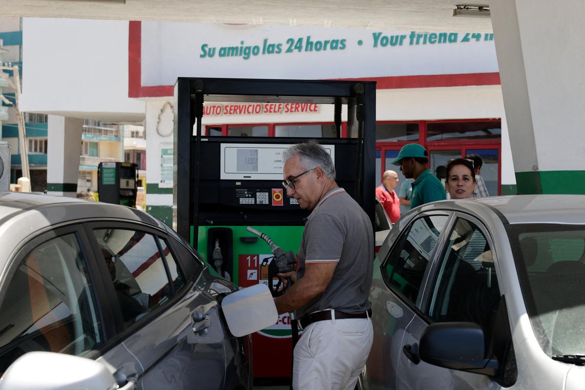 A driver fills up his tank as Cuba announces new and variable fuel prices at the pump beginning on May 15 to better reflect the actual costs of importing gas and diesel amid an ongoing U.S. fuel blockade, in Havana, Cuba, May 12, 2026. REUTERS/Norlys Perez