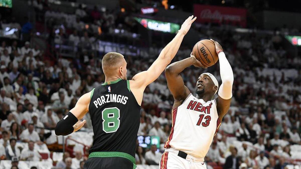  Apr 29, 2024; Miami, Florida, USA; Miami Heat center Bam Adebayo (13) shoots over Boston Celtics center Kristaps Porzingis (8) during the first quarter of game four of the first round for the 2024 NBA playoffs at Kaseya Center. Mandatory Credit: Michael Laughlin-Imagn Images | Michael Laughlin-Imagn Images 