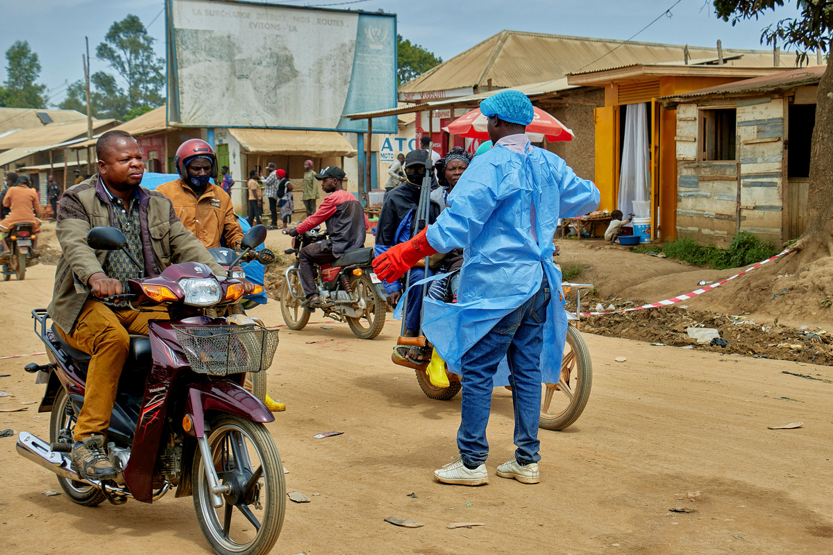 John Macki, a public health expert, controls motorcycle taxis before a health check point screening along the street, as aid agencies intensify efforts to contain a new Ebola outbreak involving the Bundibugyo strain outbreak, in Mongbwalu, Djugu Territory of Ituri province, which is the epicenter of the Ebola epidemic, in Democratic Republic of the Congo, May 23, 2026. REUTERS/Gradel Muyisa Mumbere