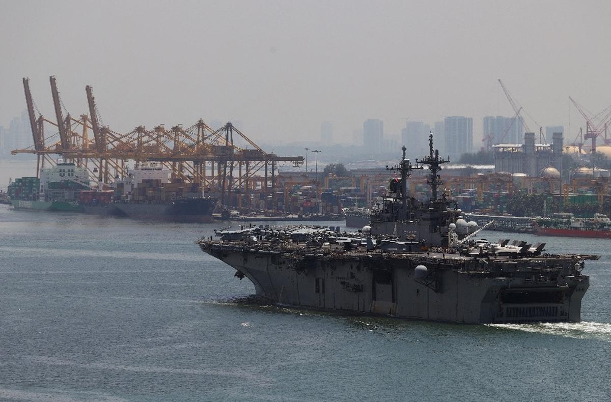 USS Boxer (LHD 4), a Wasp-class amphibious assault ship, passes the Pasir Gudang port along the Johor Strait in northeastern Singapore May 19, 2026. REUTERS/Edgar Su