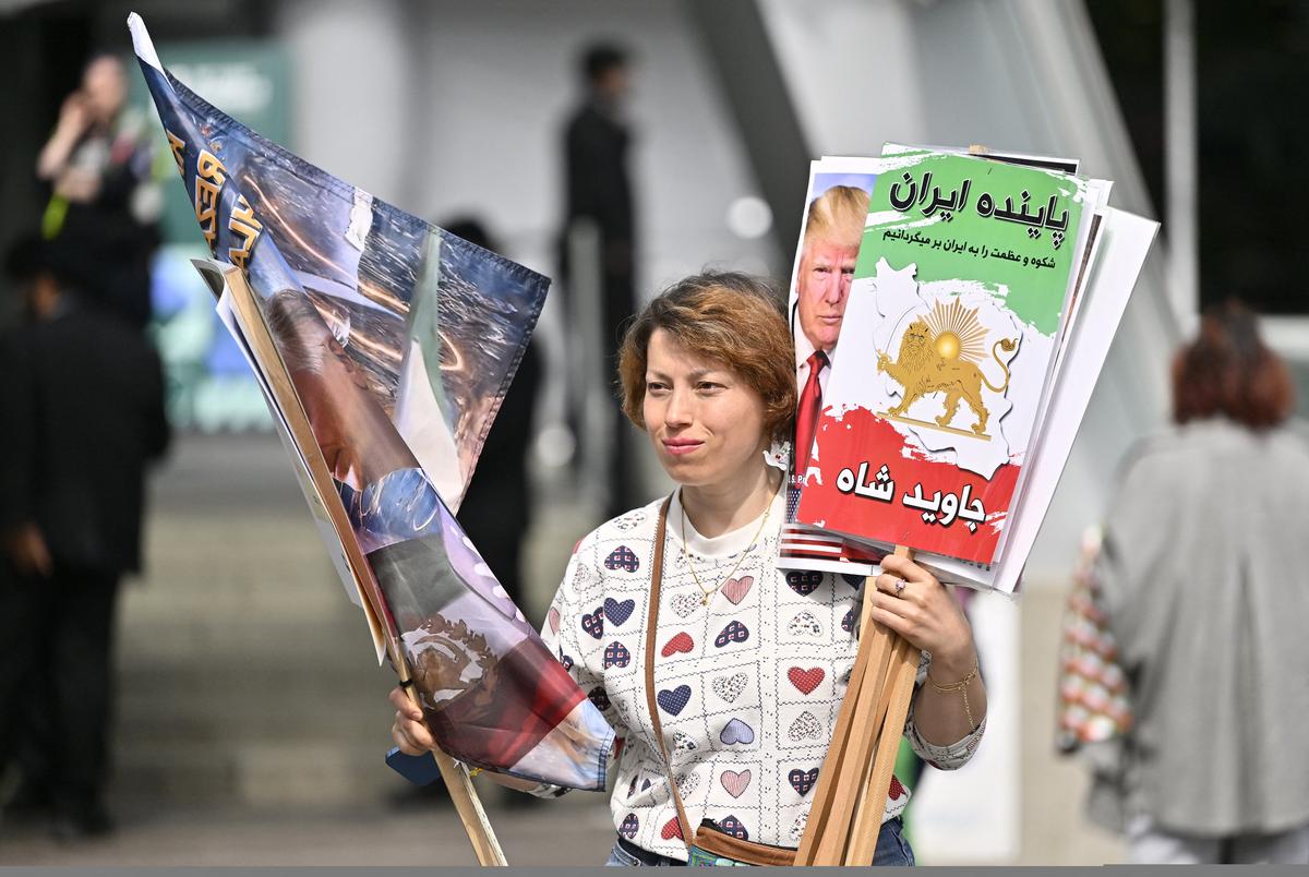 Soccer Football - 76th FIFA Congress - Vancouver Convention Centre, Vancouver, Canada - April 30, 2026  A protester holds demonstration placards outside the Vancouver Convention Centre during the 76th FIFA Congress REUTERS/Jennifer Gauthier