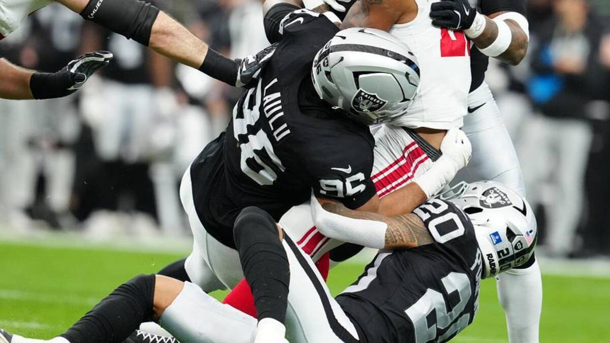 Dec 28, 2025; Paradise, Nevada, USA; New York Giants running back Tyrone Tracy Jr. (29) is brought down by Las Vegas Raiders defensive tackle Jonah Laulu (96) and safety Isaiah Pola-Mao (20) int he first quarter at Allegiant Stadium. Mandatory Credit: Stephen R. Sylvanie-Imagn Images | Stephen R. Sylvanie-Imagn Images 