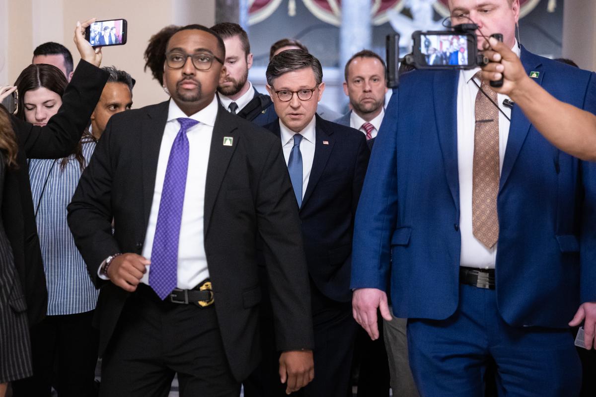  House Speaker Mike Johnson (R-La.) is surrounded by reporters and his security detail as he walks to the House chamber at the U.S. Capitol on April 30, 2026. (Francis Chung/POLITICO via AP Images) 