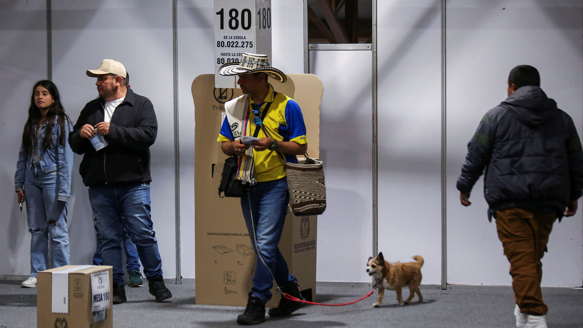 People vote at Colombia's largest polling station, called Corferias, during a runoff between right-wing presidential candidate Abelardo De La Espriella and leftist candidate Ivan Cepeda in Bogota on Sunday