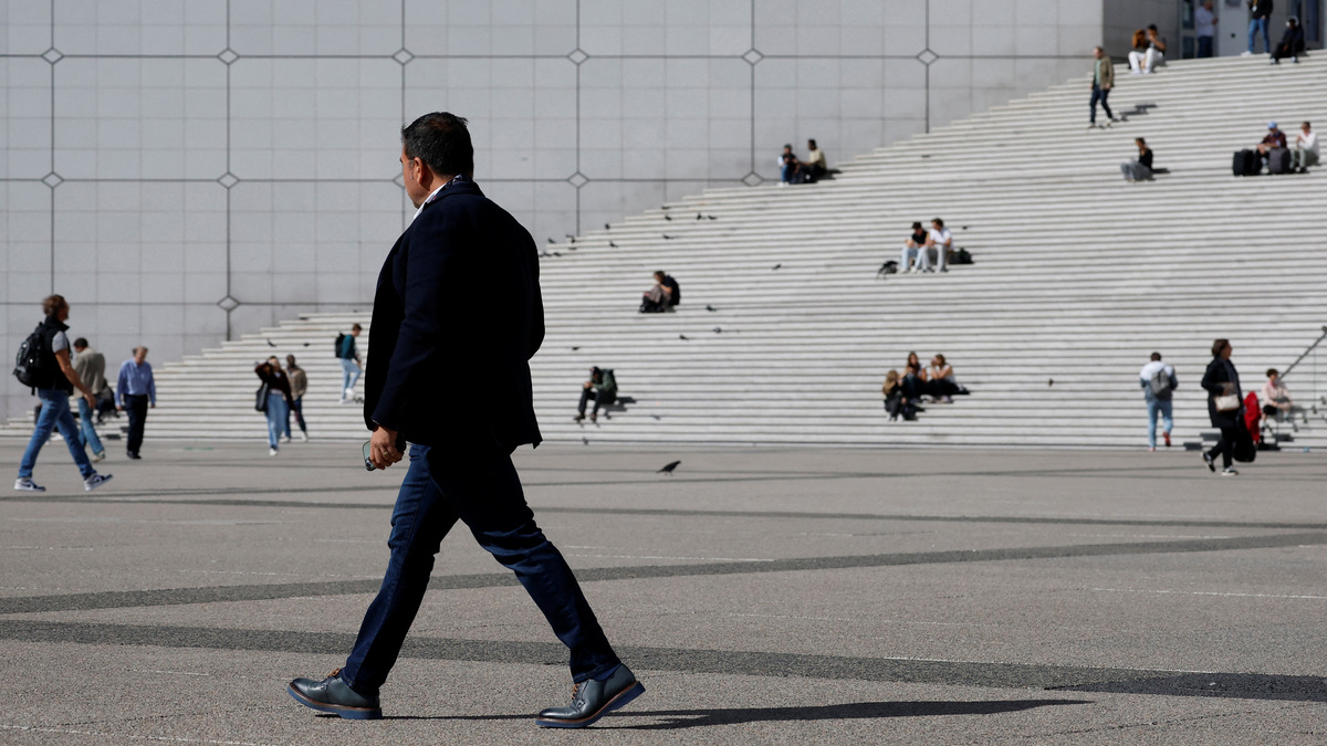 A man walks past the steps near the Grande Arche at the financial and business district of La Defense in Puteaux near Paris, france, September 12, 2025. REUTERS/Stephanie Lecocq