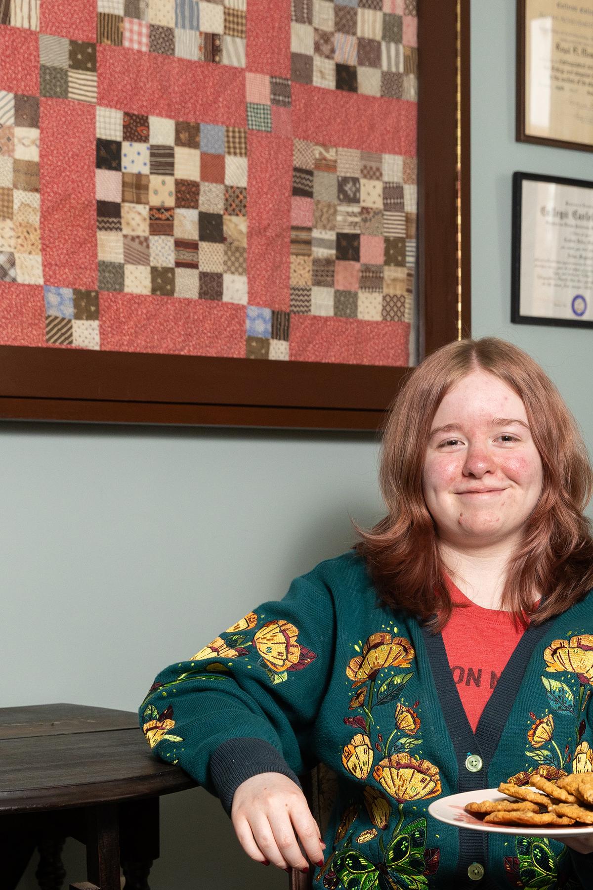 Elspeth Stoner, a freshman, with a plate of cookies at the Dacie Moses House, Carleton College's cookie house in Northfield, Minn., March 30, 2026. For decades, Carleton College has kept a place where students and others can come, bake and share. (Liam James Doyle/The New York Times)