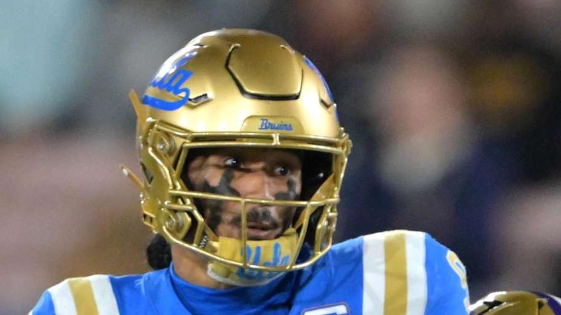  Nov 22, 2025; Pasadena, California, USA; UCLA Bruins quarterback Nico Iamaleava (9) is pressured by Washington Huskies linebacker Zach Durfee (5) during the first half at the Rose Bowl. Mandatory Credit: Jayne Kamin-Oncea-Imagn Images | Jayne Kamin-Oncea-Imagn Images 