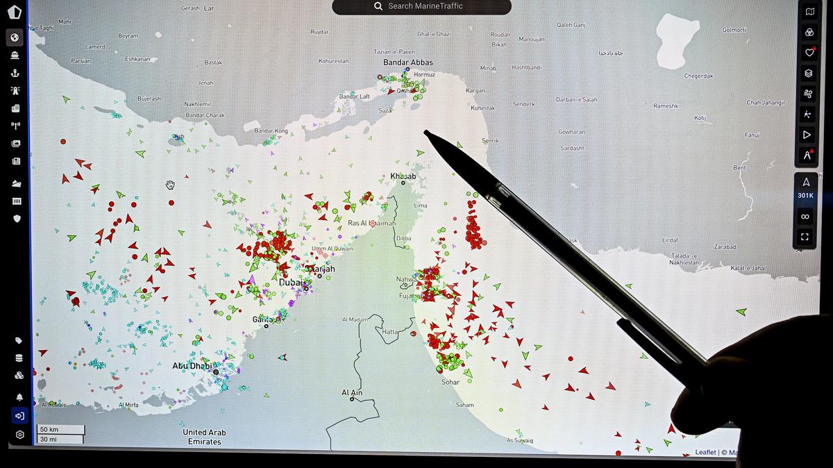 A person points at a page on the Marine Traffic website that shows commercial boat traffic on the edge of the Strait of Hormuz near the Iranian coast on March 4, 2026. (Julien De Rosa/AFP/Getty Images/TNS)