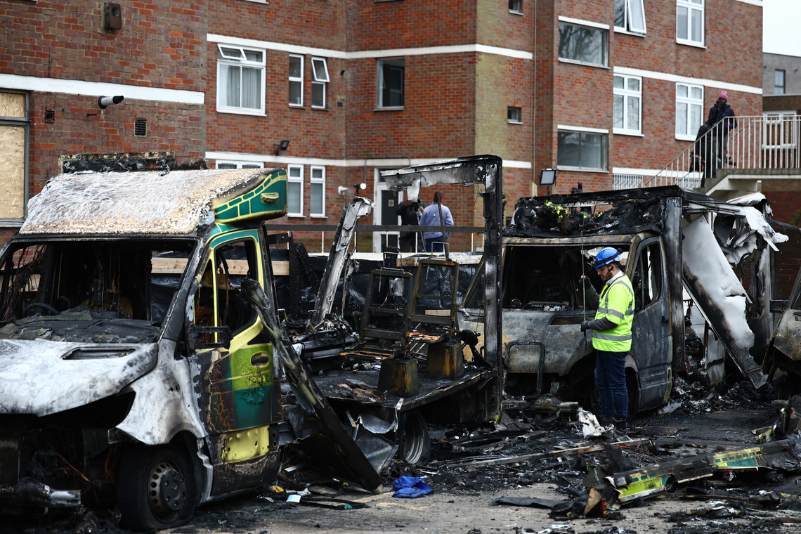  An official works among the burnt-out ambulances at the scene of an antisemitic arson attack in the Golders Green neighbourhood of north London, on March 24, 2026. 