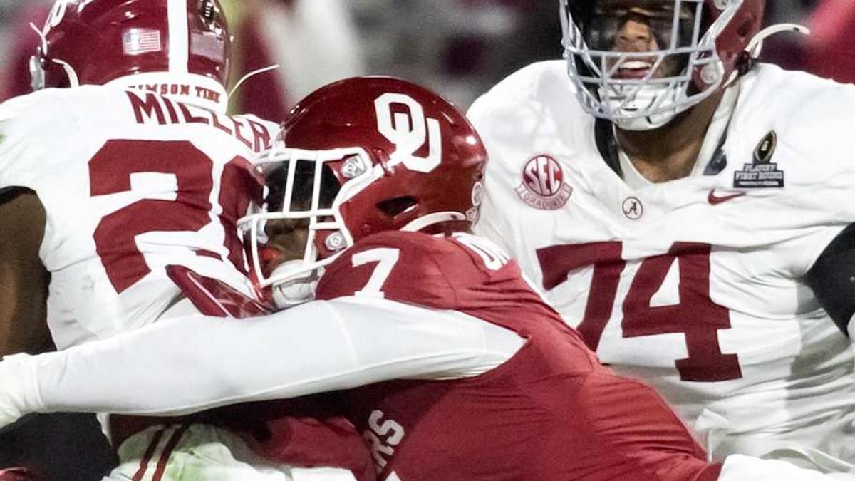  Dec 19, 2025; Norman, OK, USA; Oklahoma Sooners linebacker Sammy Omosigho (7) tackles Alabama Crimson Tide running back Jam Miller (26) during the CFP National Playoff First Round at Gaylord Family Oklahoma Memorial Stadium. Mandatory Credit: Mark J. Rebilas-Imagn Images | Mark J. Rebilas-Imagn Images 
