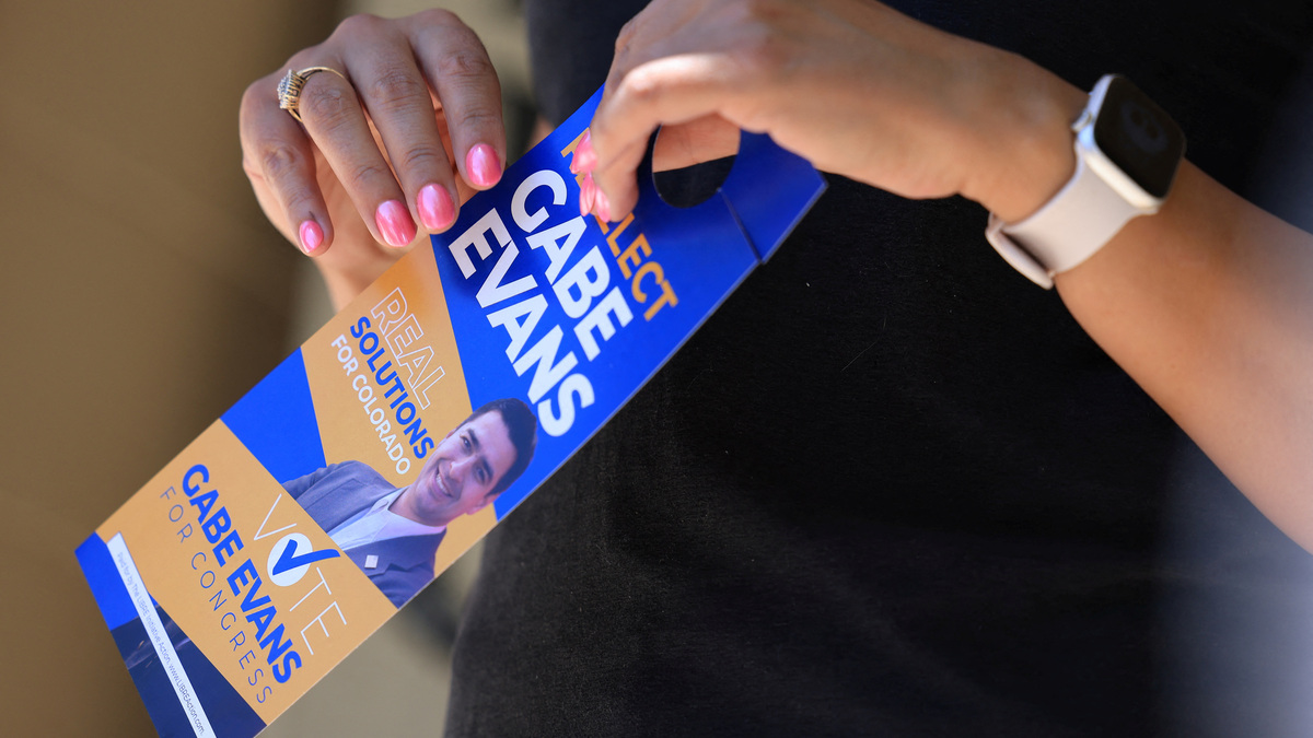 Gayle Sandoval holds a flyer supporting U.S. Rep. Gabe Evans (R-CO) in Brighton, Colorado, U.S., June 11, 2026. REUTERS/Kevin Mohatt